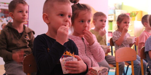 Dzieci jedzą popkorn